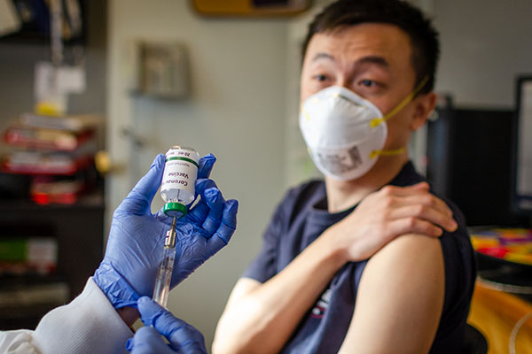 Chinese male receiving coronavirus vaccine in clinic