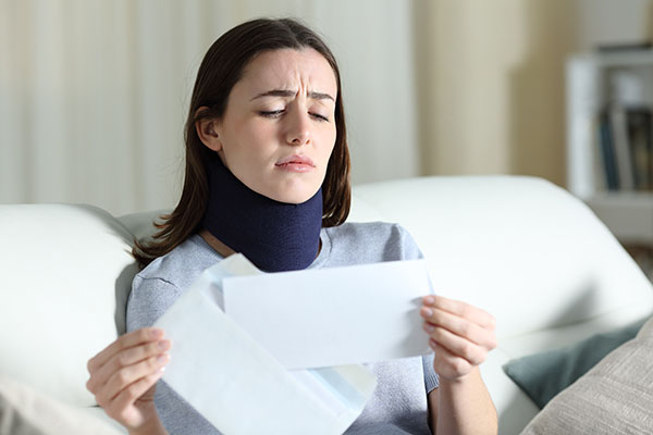 Sad disabled woman reading bad news on letter