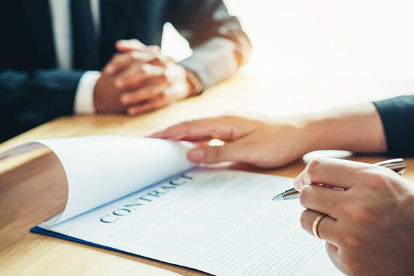 Business people negotiating a contract between two colleagues